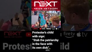 Protestor's child holds sign: “Stab the patriarchy in the face with its own dick”