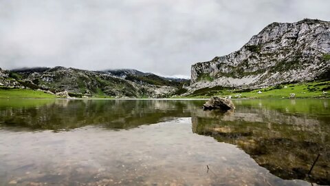 Soothing sound of rain hitting a calm lake in a beautiful mountain scenery