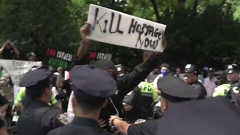 Masked Protester Taunts New York City Israel Day Parade With "Kill Hostages Now" Sign