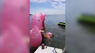 Guy Tries To Climb Inflatable Flamingo Fails Miserably
