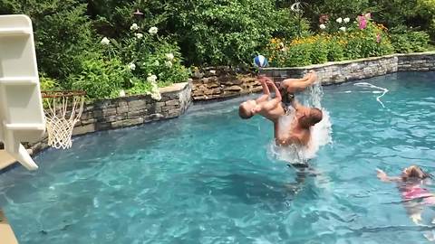 A Boy Makes A Backward Flip In A Pool And Scores A Hoop
