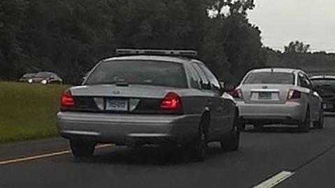 Tailgating cop muscles his way down highway