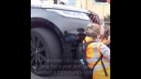 A woman who attempted to use a car to move protesters has been banned from driving.