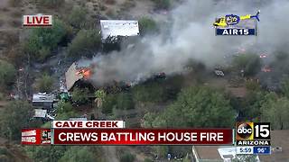 House fire spreads to nearby brush in Cave Creek