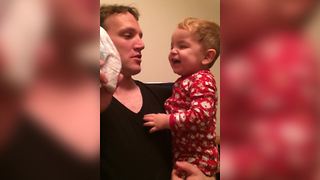 Baby Boy Laughs At His Dad Kissing A Diaper