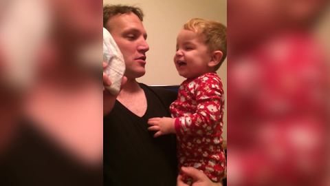 Baby Boy Laughs At His Dad Kissing A Diaper