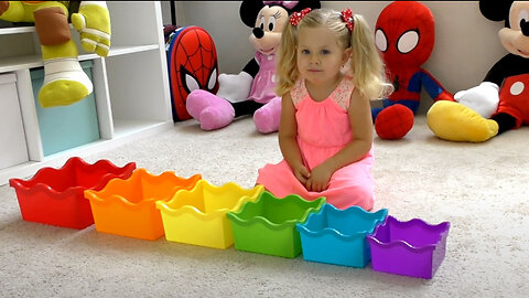 Diana plays with colored toy Pyramid