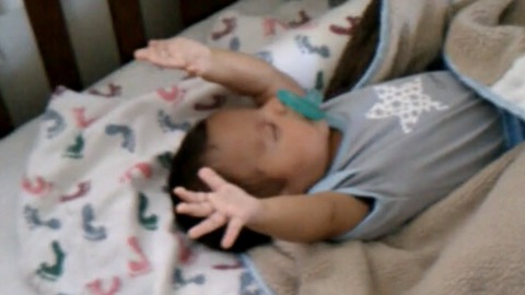 Baby Boy Raises His Arms As He Sleeps