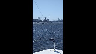 Battleship New Jersey passing under a bridge