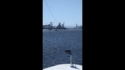 Battleship New Jersey passing under a bridge