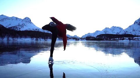 Girl Performs Amazing Ice Skating Act Amidst Mountains In Switzerland