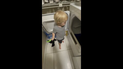 Toddler Helps Daddy Put Clothes in the Dryer