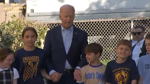 What is strange in this video of a group of children walking Joe Biden? Everything.
