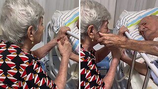 Grandma preciously sings to her husband to ease his suffering