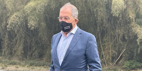 Russian foreign minister Lavrov poses wearing a black mask that says "Fucking Quarantine"