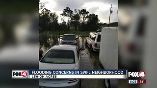 Couple trudges through flooding to go to work