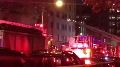 Fire crews try to rescue occupants reportedly trapped in apartment fire