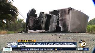 Overturned box truck shuts down road