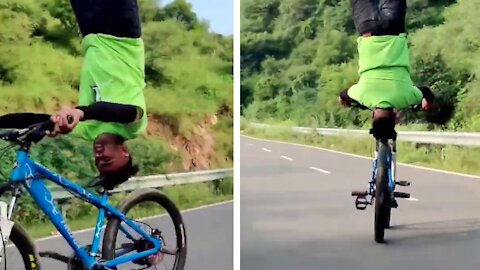 Guy performs bicycle tricks