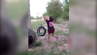 A Teen Girl Runs And Jumps Onto A Tire Swing And Ends Up On The Ground