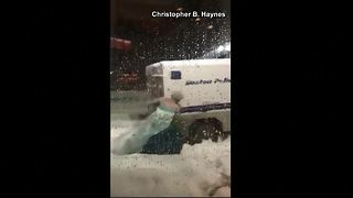 Man dressed as "Elsa" from Frozen pushes police truck out of snow