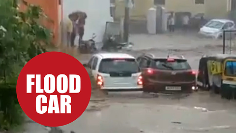 Four men had a lucky escape just seconds before their car was washed away in a flood