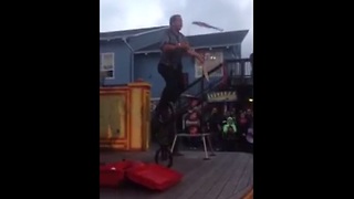 Man juggles 3 knives while riding a 3-wheeled unicycle!