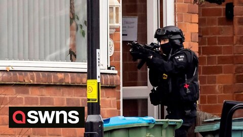 Police siege at UK house continues as dad remains holed up with son armed with weapons