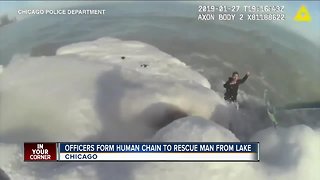 Officers form human chain to rescue man from lake