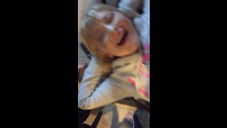 Girl laughs while getting her belly button pierced