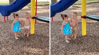 Sweet Baby Boy Holds Hands With Little Girl at the Park
