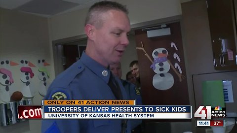 Highway patrol troopers on both sides of state line bring gifts to young patients