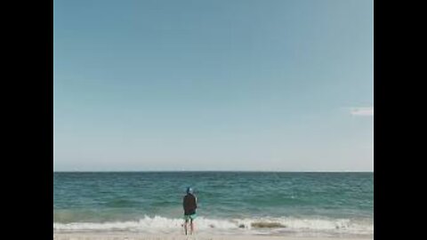 Long Shot of Male Surfer Surfing in Ocean in Bali