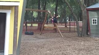 A Young Boy Fails To Jump Off A Swing