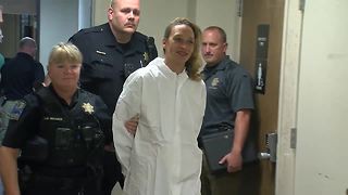 Woman accused of stabbing daughter seen smiling after arrest