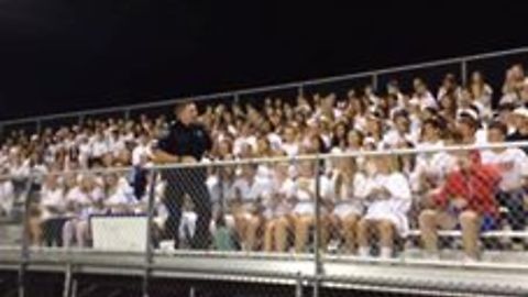 Police officer gets crowed pumped up during football game