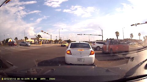 Traffic lights malfunction and truck almost collides with minivan.