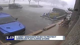 2 Army Sergeants rush to protect American flag during storm