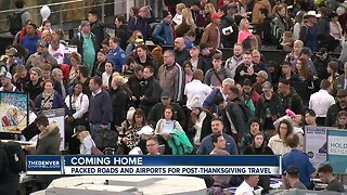 Travelers navigate holiday crowds at Denver International Airport