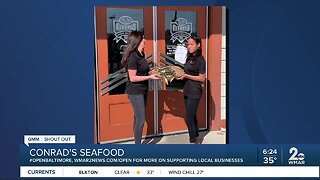 Conrad's Seafood says "We're Open Baltimore!"
