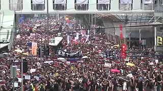 Huge crowds march in Hong Kong, piling pressure on leader