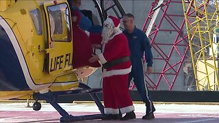Santa Claus lands in a helicopter at Metrohealth to deliver presents to kids
