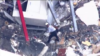 Fire rescue dogs searching through rubble after Surfside building collapse