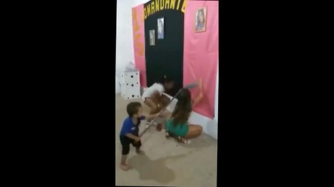 kid hits chick over the head with a broom for dancing badly