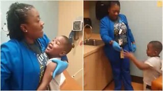Nurse calms child getting a shot...by giving him $5!