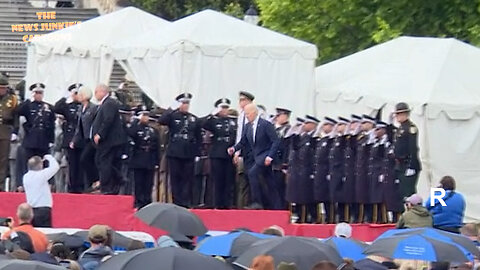 Biden trips again as he's led on stage at the national Peace Officers Memorial Service.