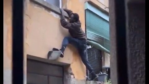 Invader in Milan, Italy climbing through second story window to make sure the occupants are safe