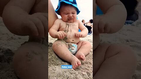 Funny baby reaction on the beach