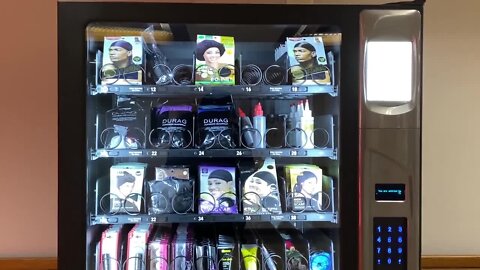 UM students open a vending machine filled with Black hair care products for students of color