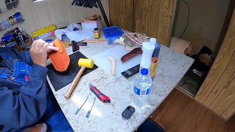 Dyeing, gluing, punching holes and sewing a sheath